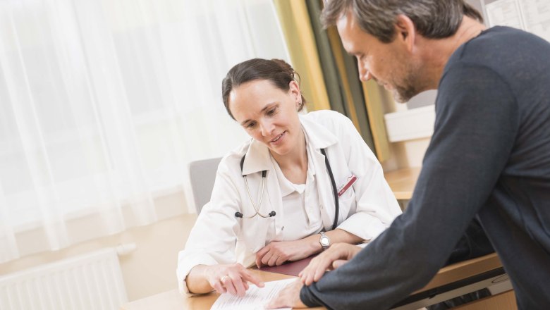 Arztgespräch, © Lebens.Resort Ottenschlag Ein Arzt und ein Patient sitzen an einem Tisch und besprechen ein Dokument.